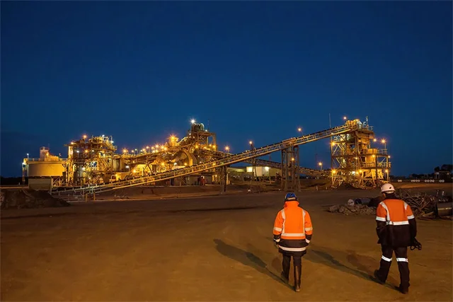 Workers at remote mining operations site at night